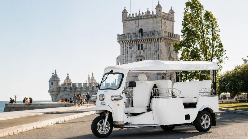 David's tuk-tuk parked in front of Belém Tower
